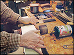 John Greven attaches sides of guitar in a form